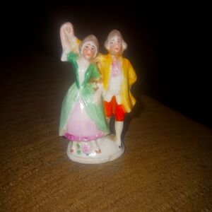 Porcelain Figurine with Green and Yellow Accents. Colonial Dancing Couple.